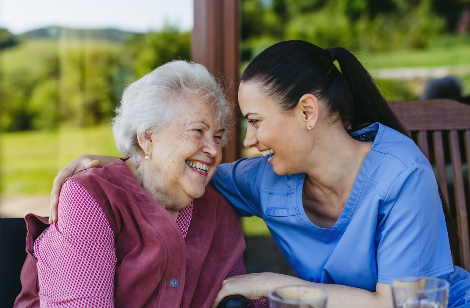 An older adult bonds with care staff while in memory care