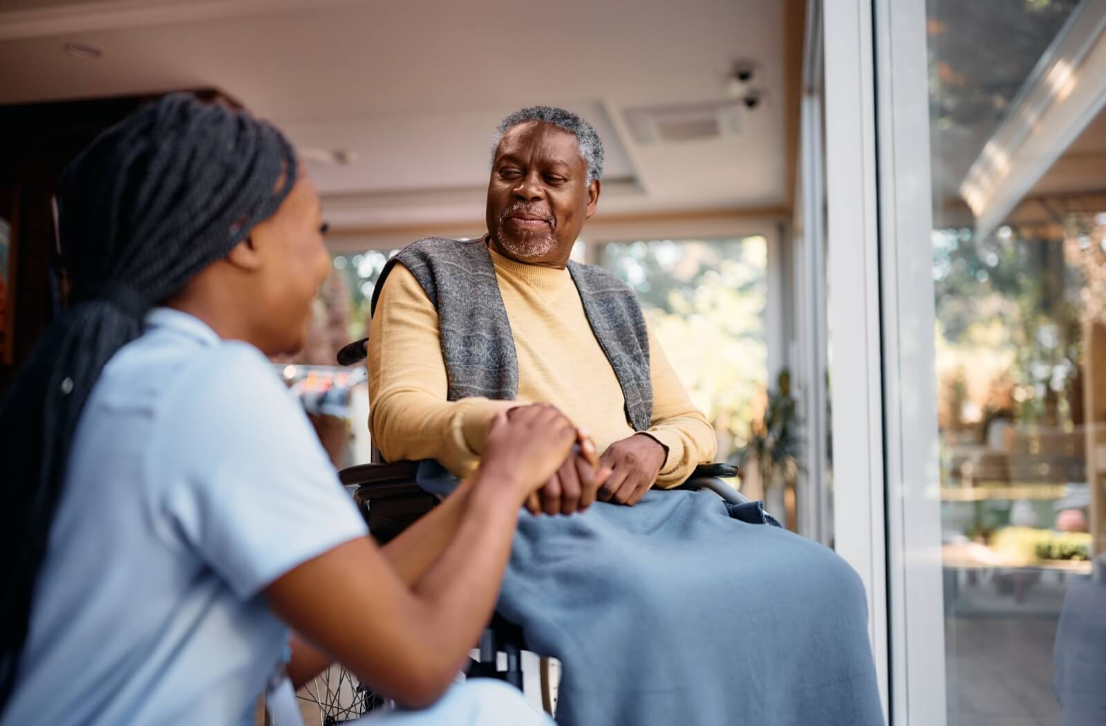 A senior with a nurse at a nursing home